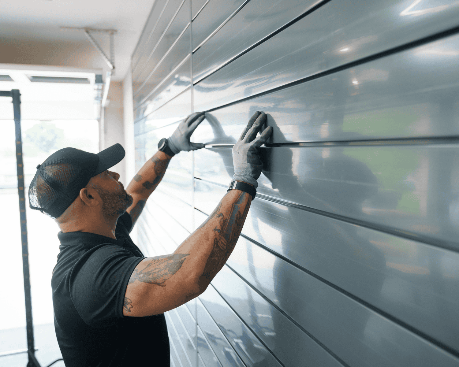 a professional technician installing slat walls onto a garage wall
