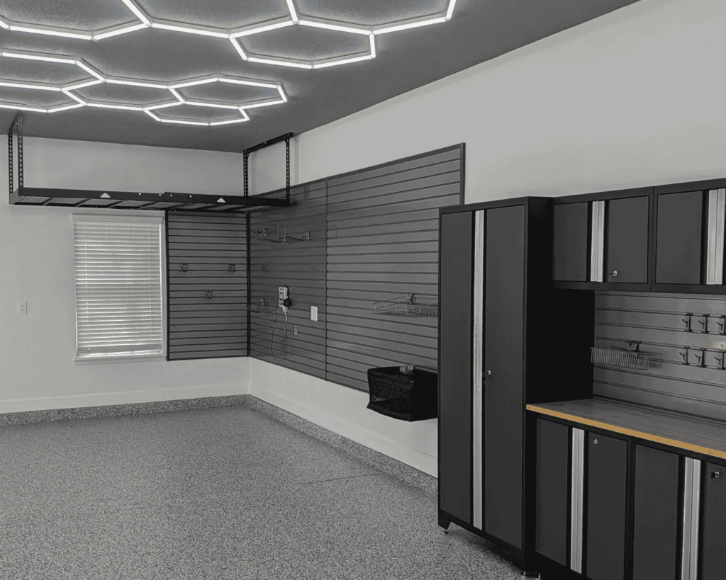 a new garage renovation project with freshly installed cabinets, slat walls, and hex lights