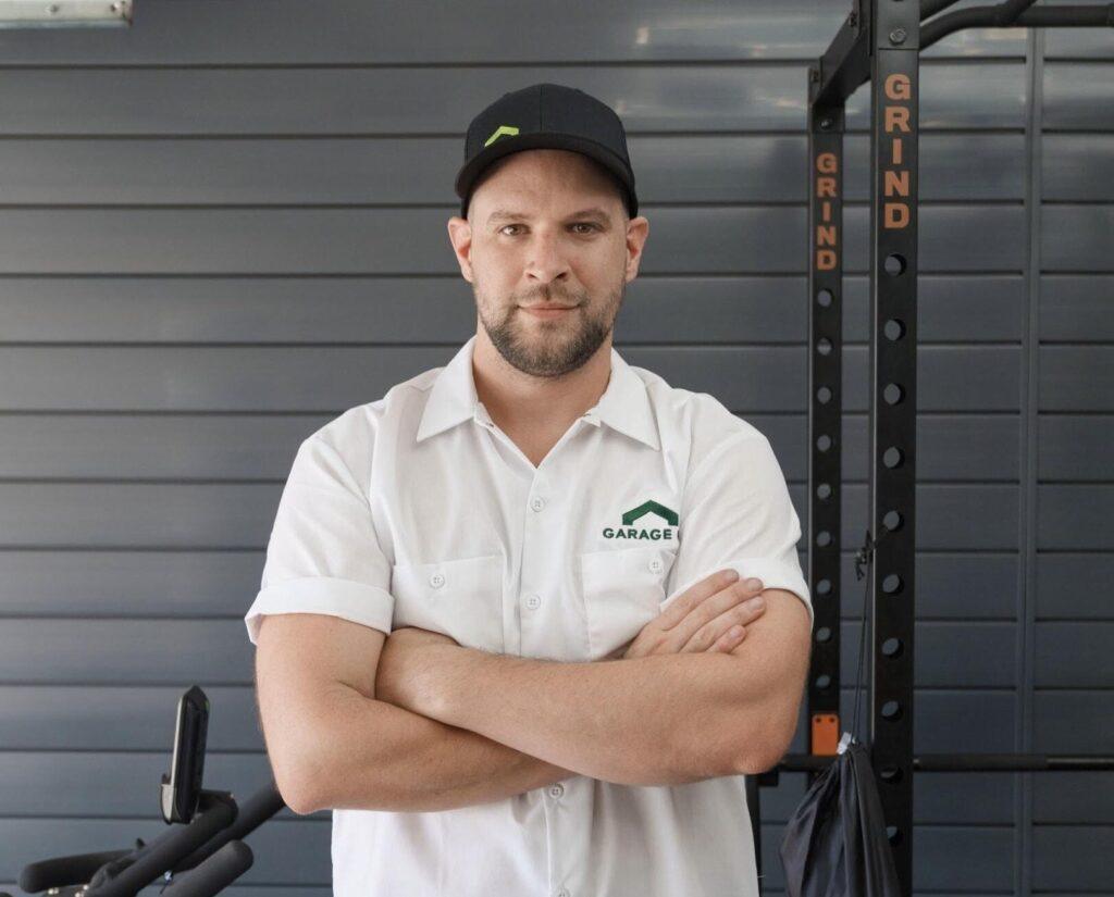 A Garage Up owner posing in a freshly renovated garage. Garage contractor. estimate