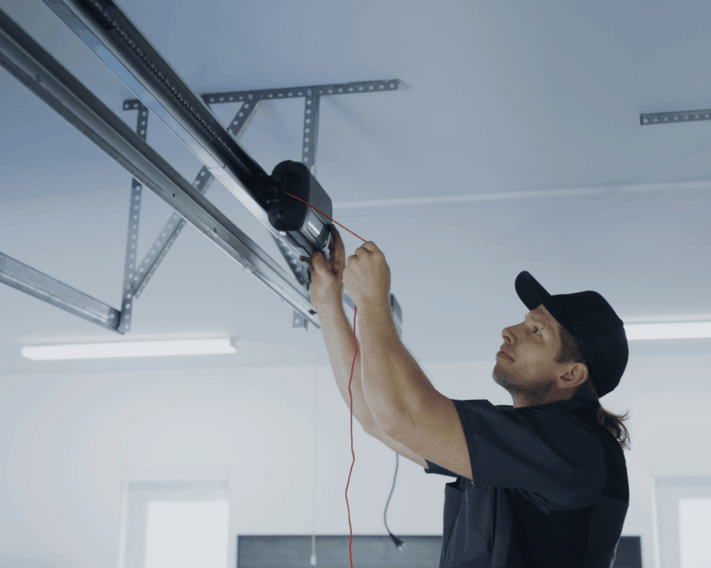 a garage up employee installing a motor inside a residential garage