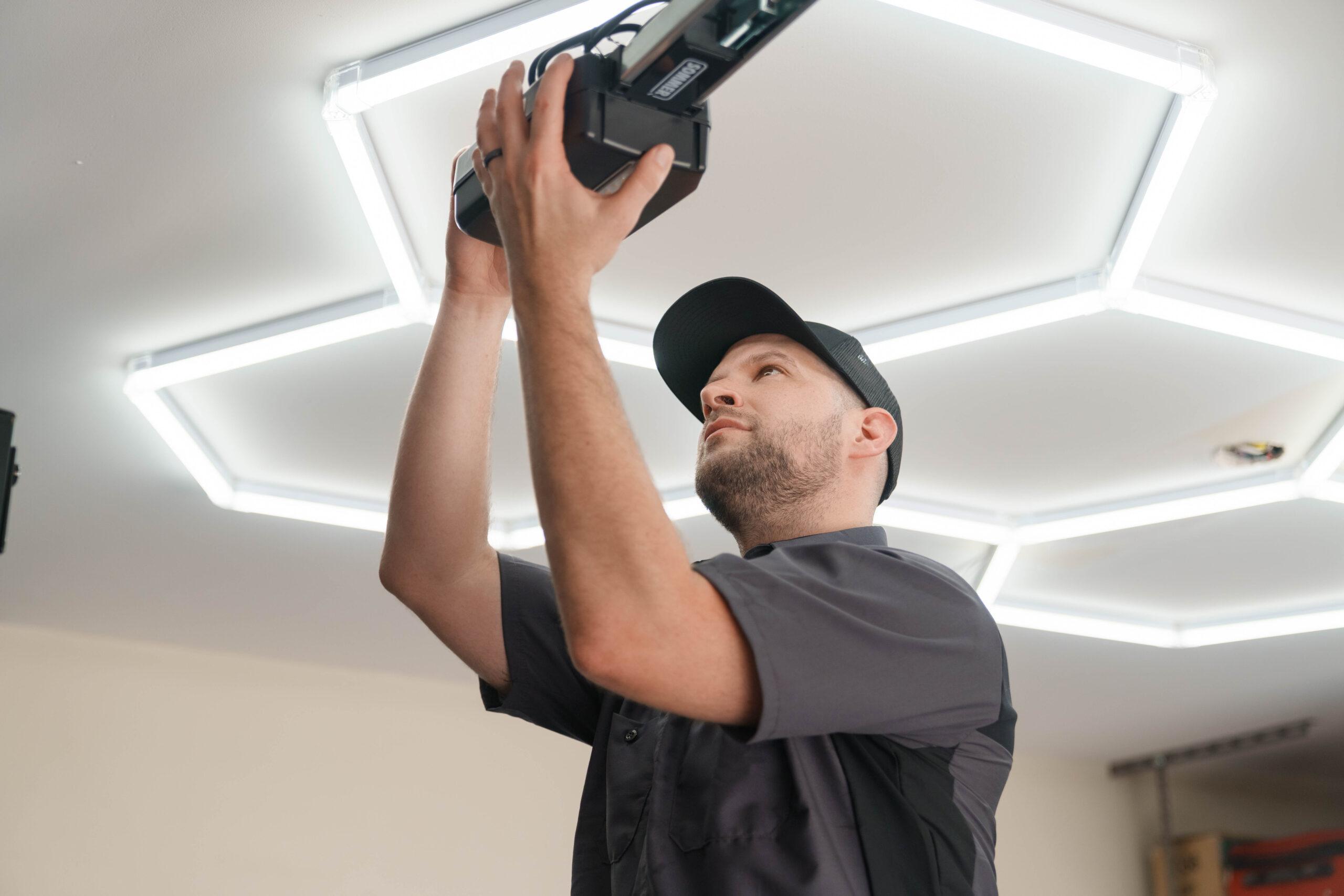A Garage Up worker checking the motor to a garage door. Garage door opener installation.