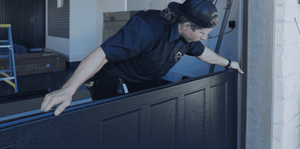 A professional garage door technician installing a new garage door for garage door repair and replacement