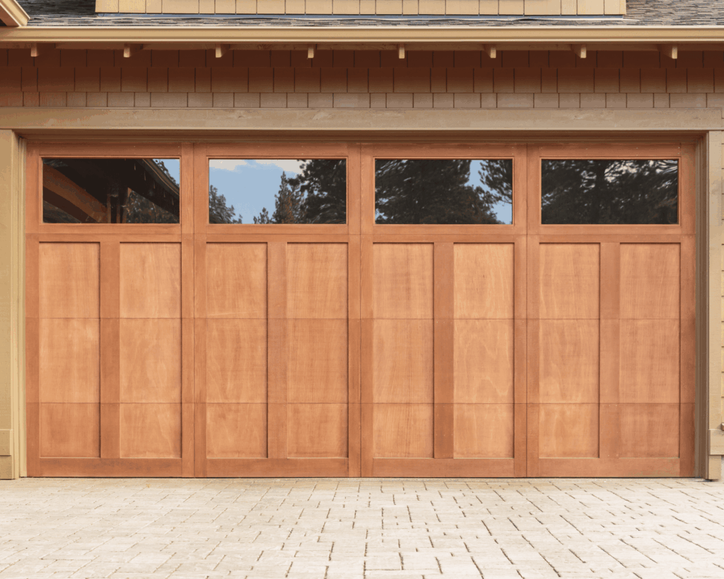 Contemporary wooden garage door with rectangular windows at the top added through garage renovations in berkely