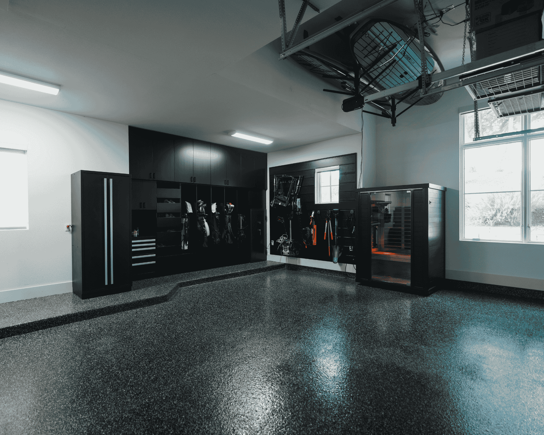 A garage renovation featuring brand new flooring and cabinetry.