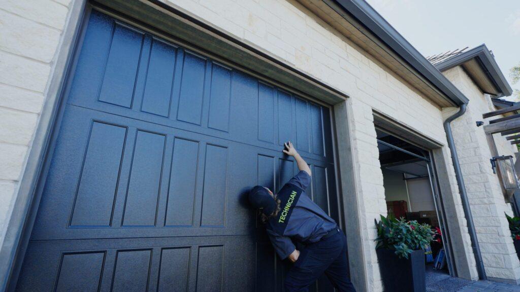 A Garage Up employee checking a garage door that was recently renovated.