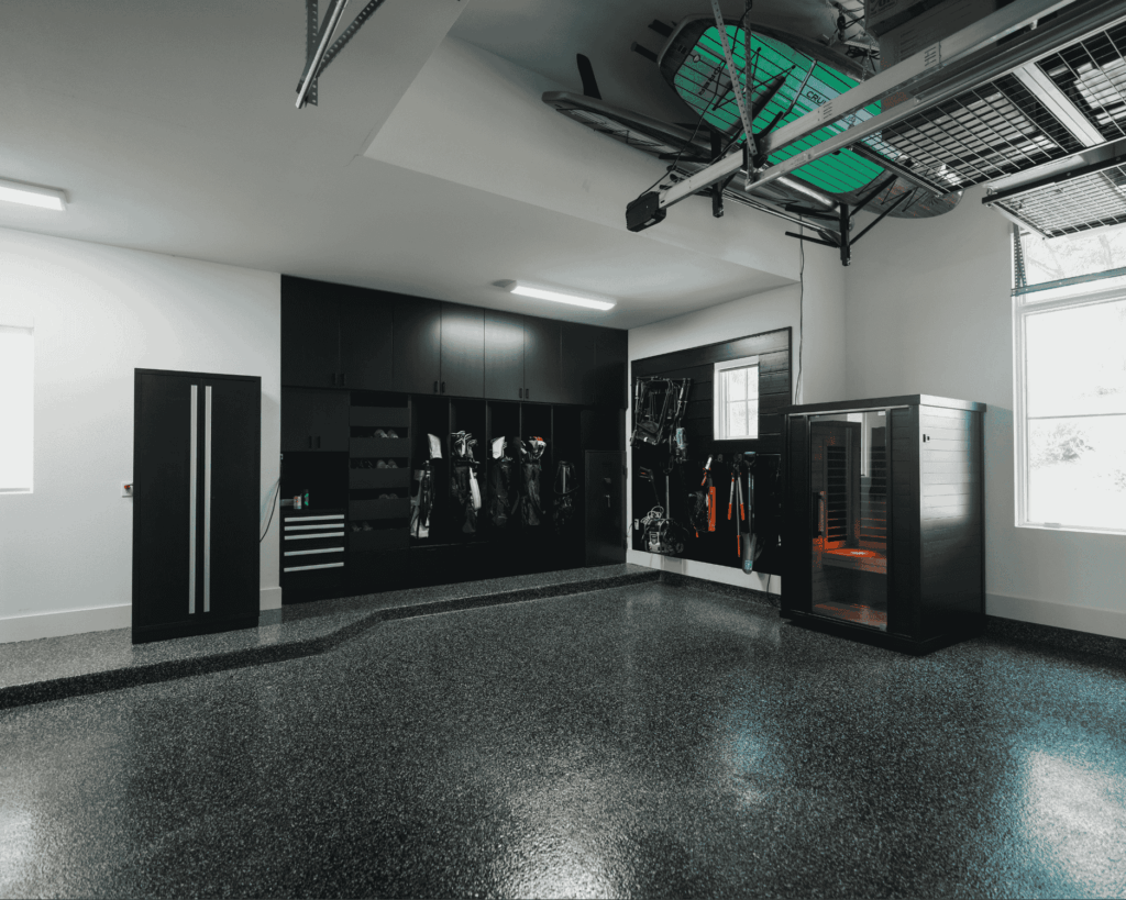 a completely renovated garage with custom storage and overhead racks installed by Garage Up - garage renovation