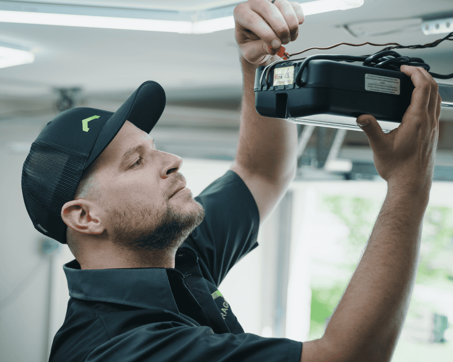 a professional technician at Garage Up working on a motor replacement as part of our garage renovations services