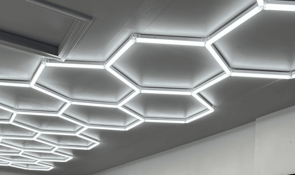 A series of hexagon lights mounted to the ceiling for a garage renovation.