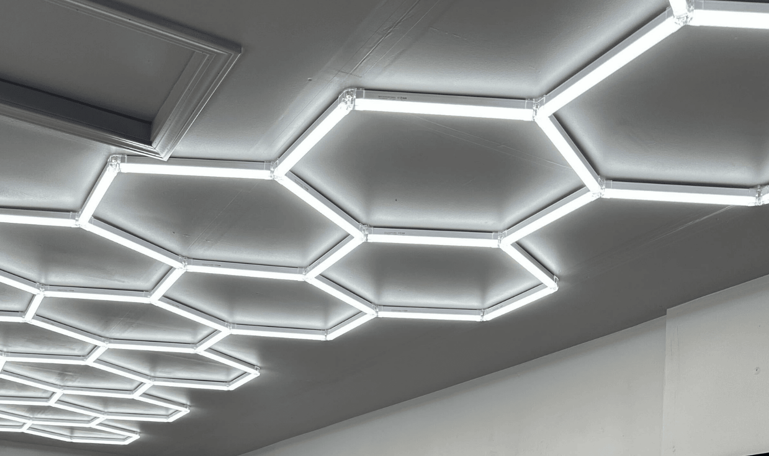A series of hexagon lights mounted to the ceiling for a garage renovation.
