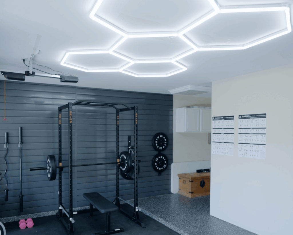 Hex lighting, epoxy flooring and wall paneling all put into place for the ultimate at-home gym.
