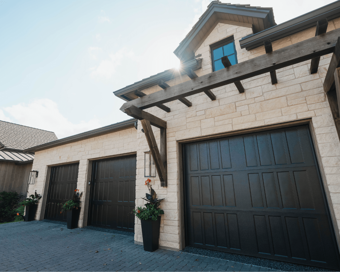 A photo of the outside of a home with three garage doors that recently went through a garage renovation with Garage Up.