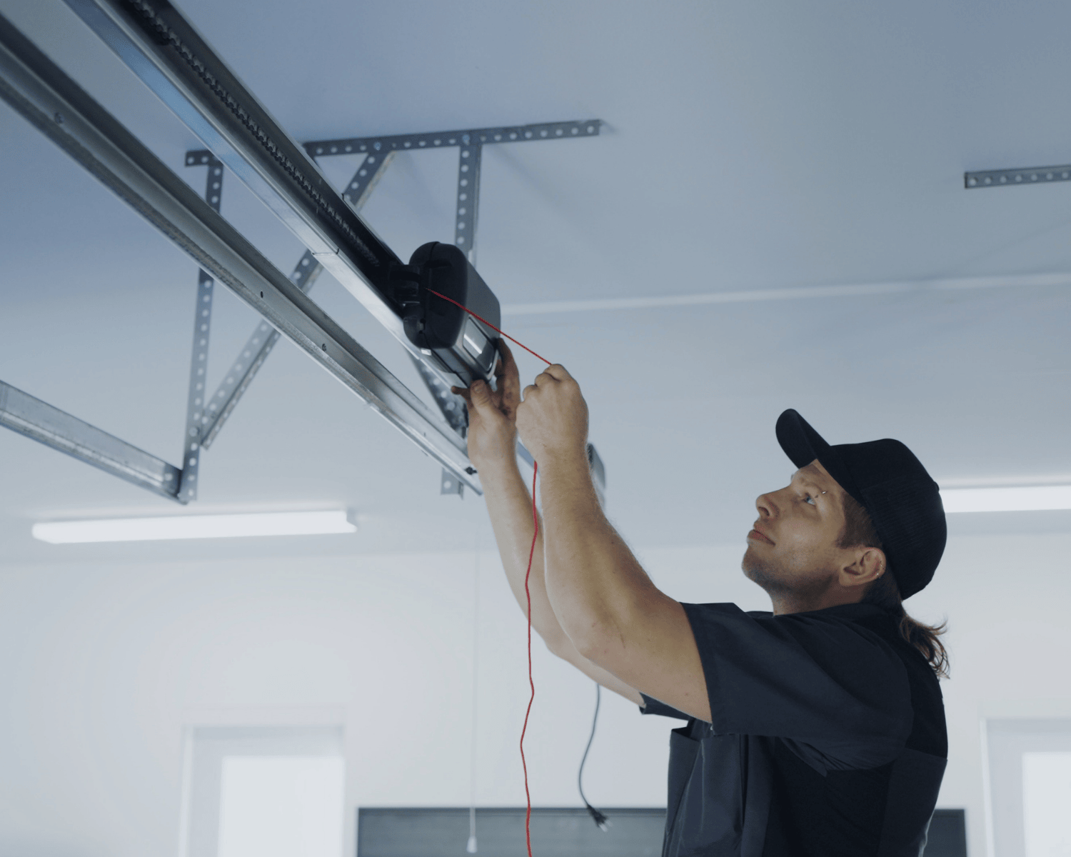 A professional garage technician from Garage Up working to fix the motor of a broken garage door.