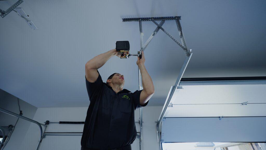 Garage Up technicians working on garage door repairs.