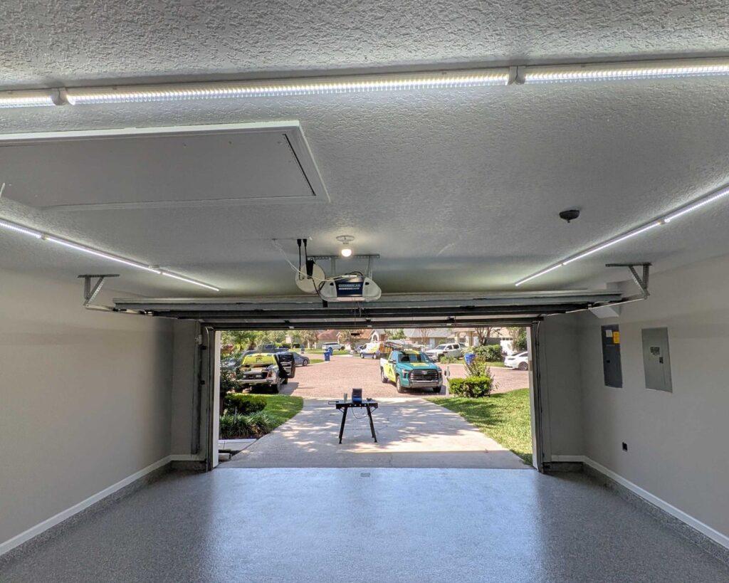 a garage with linear lights on along the borders of the ceiling