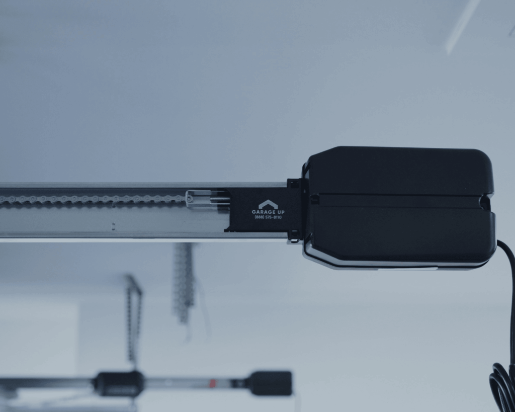 A close up of a garage door motor with the Garage Up logo