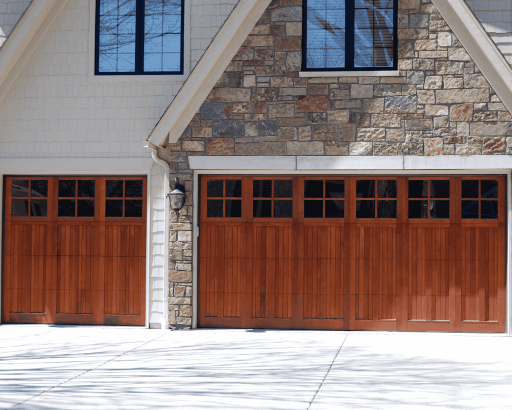 a three car garage in a residential home with walnut classic doors