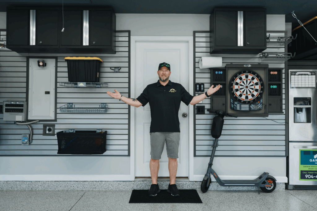 A Garage Up Owner posing in a garage that him and his team just renovated.