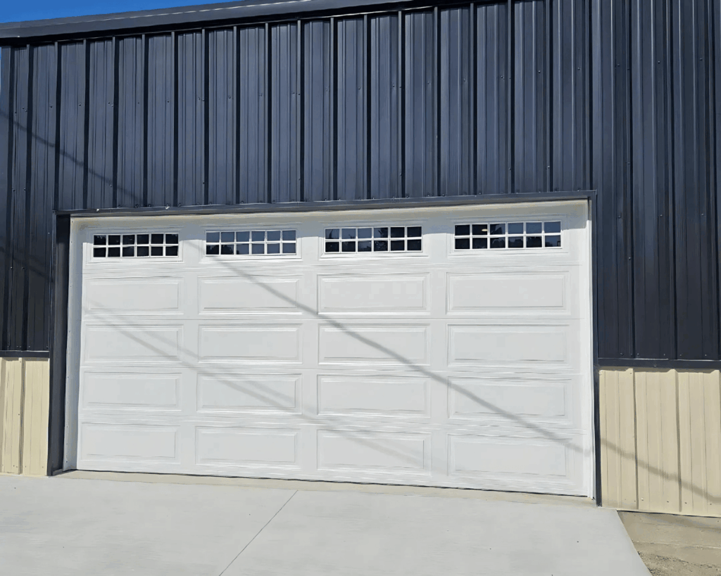 a white commercial garage door installed by a technician at garage up