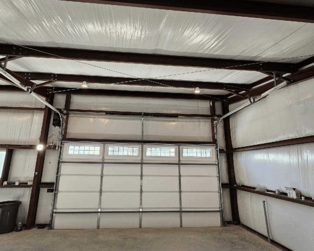 the inside of a commercial garage with an insulated white door