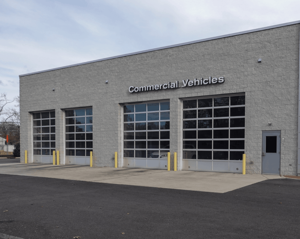 a commercial vehicles garage with four different full-view doors