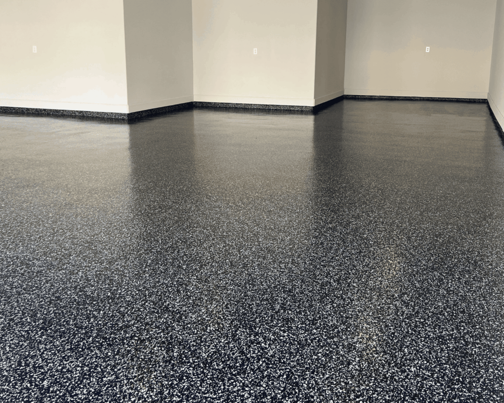 a newly installed epoxy floor by technicians at garage up