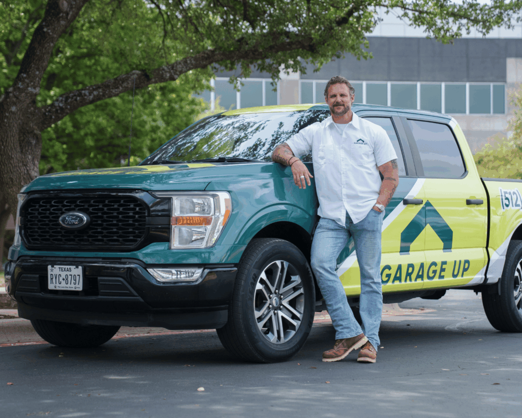 happy franchisee standing by work truck smiling